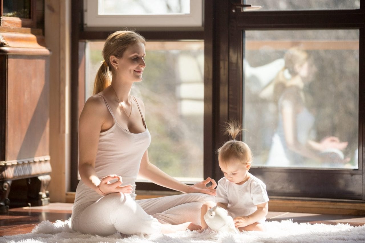 Tips for new mums - Mum doing yoga with baby. Practicing self-care. Tips for new mums