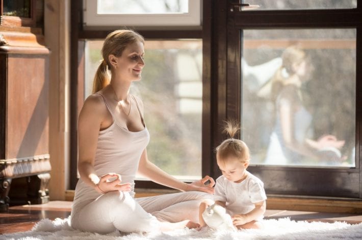 Tips for new mums - Mum doing yoga with baby. Practicing self-care. Tips for new mums