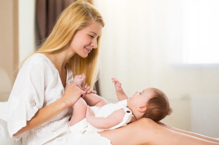 newborn - new mum bonding with baby in a bubble of baby love