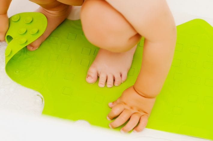 baby on bath mat showing baby safety at bathtime