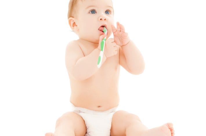 baby teething biting on toothbrush