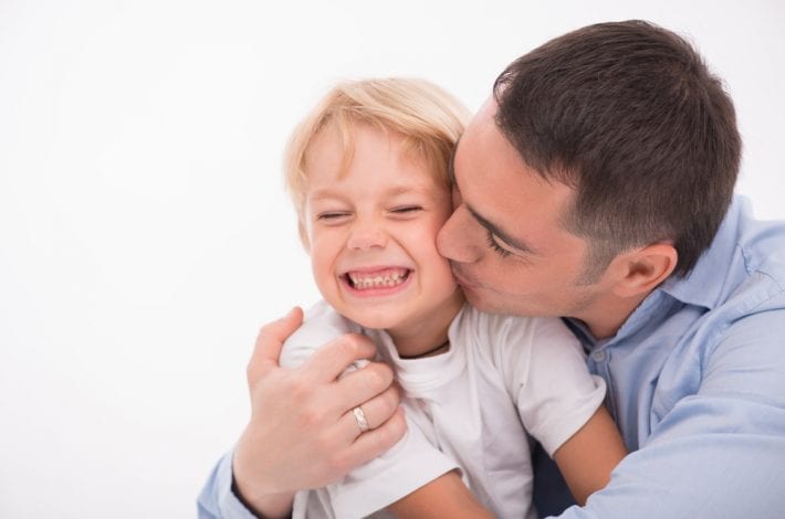 father kissing son praising him