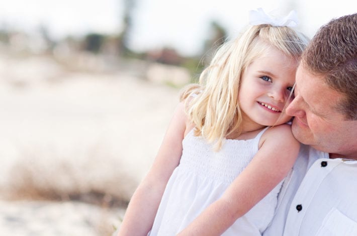 father reassuring daughter and cuddling