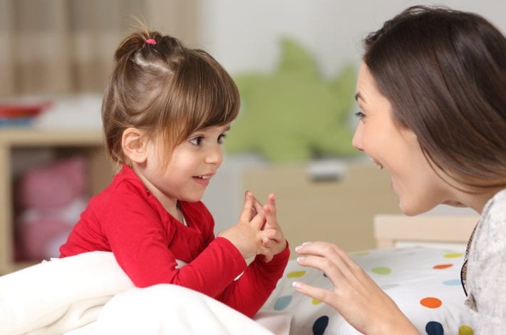 mother being positive with young daughter