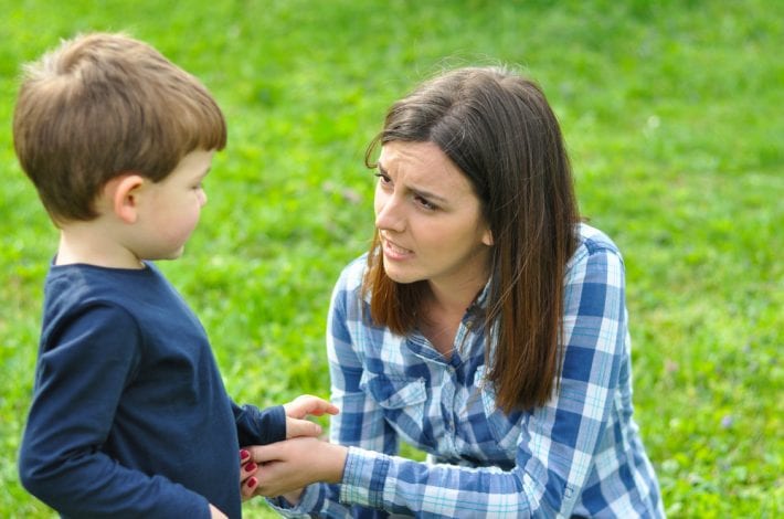 mother removing toddler from situation