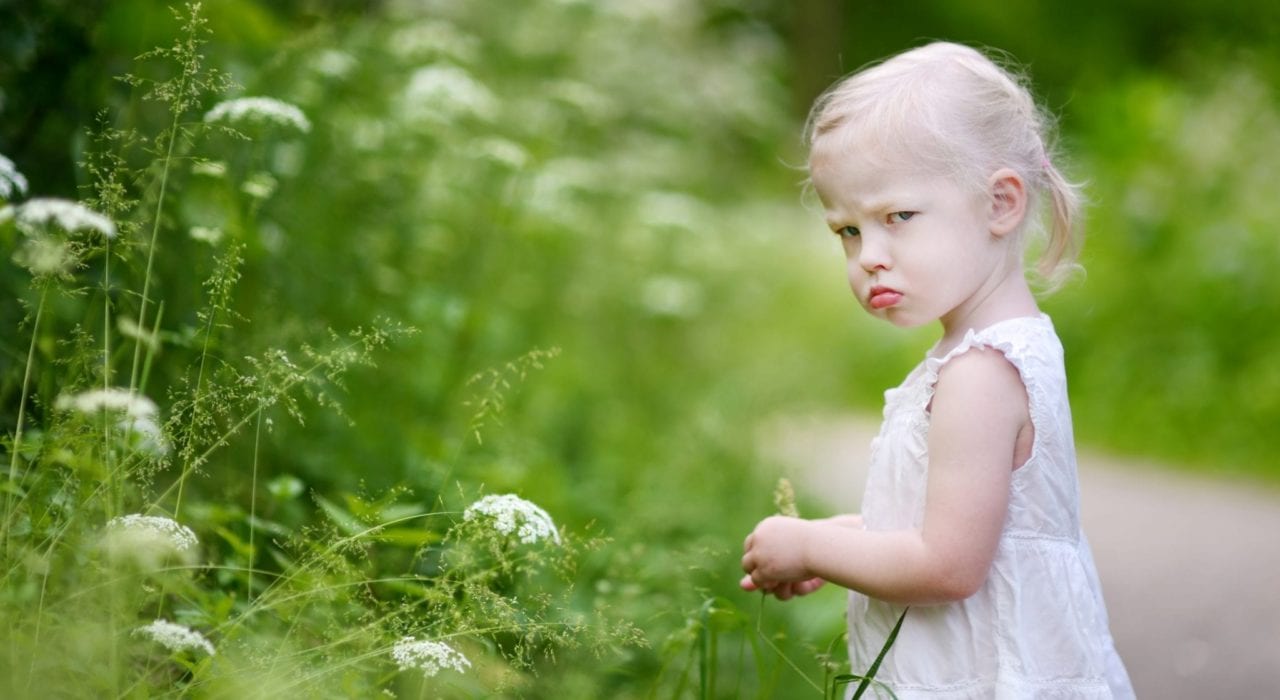 toddler girl looking grumpy and moody terrible twos