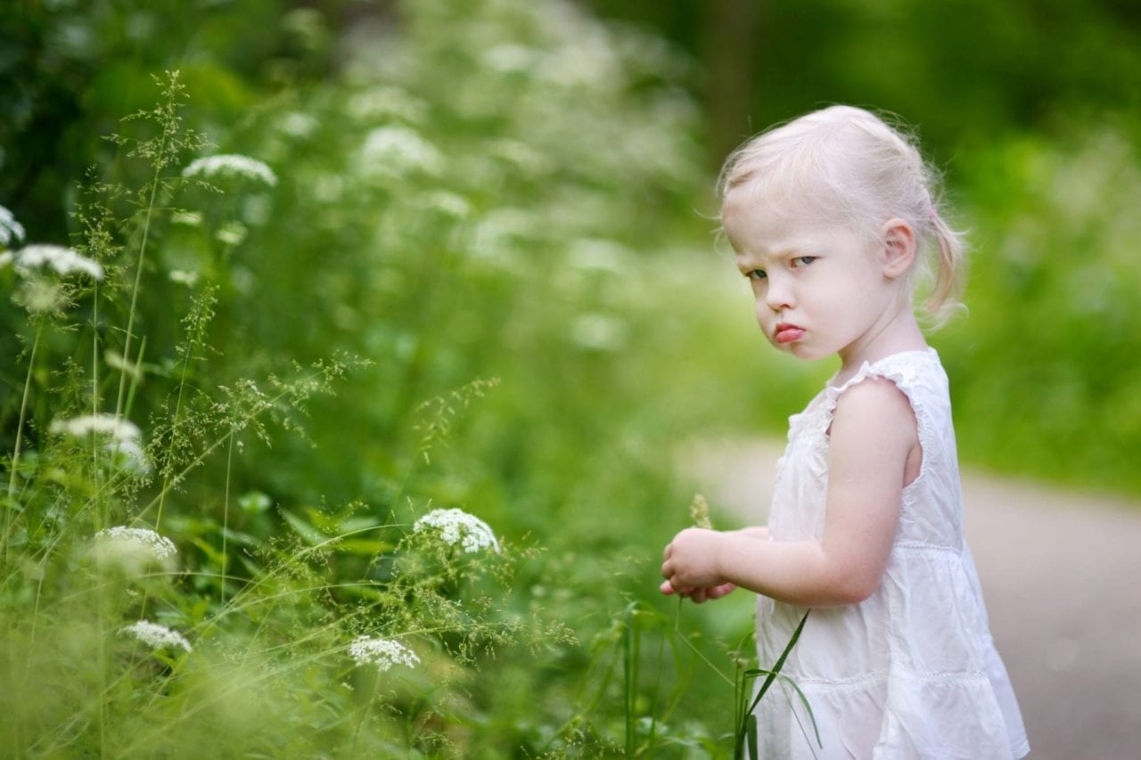 toddler girl looking grumpy and moody terrible twos