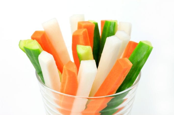 carrot cucumber and celery sticks in a plastic cup