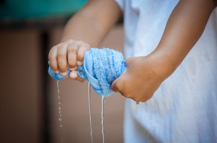 wet towel being squeezed