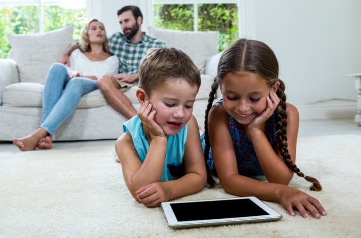 child safe online - children on ipad with parents on sofa