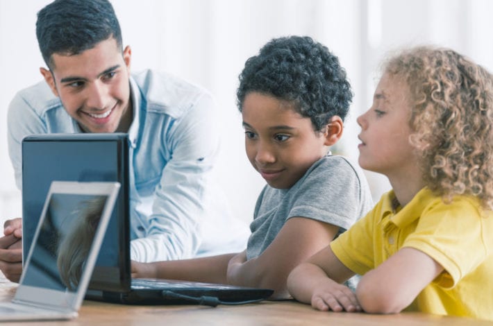 child safe online - dad guiding boys online