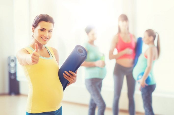 exercising during pregnancy - tips for staying safe - pregnant woman giving a thumbs up