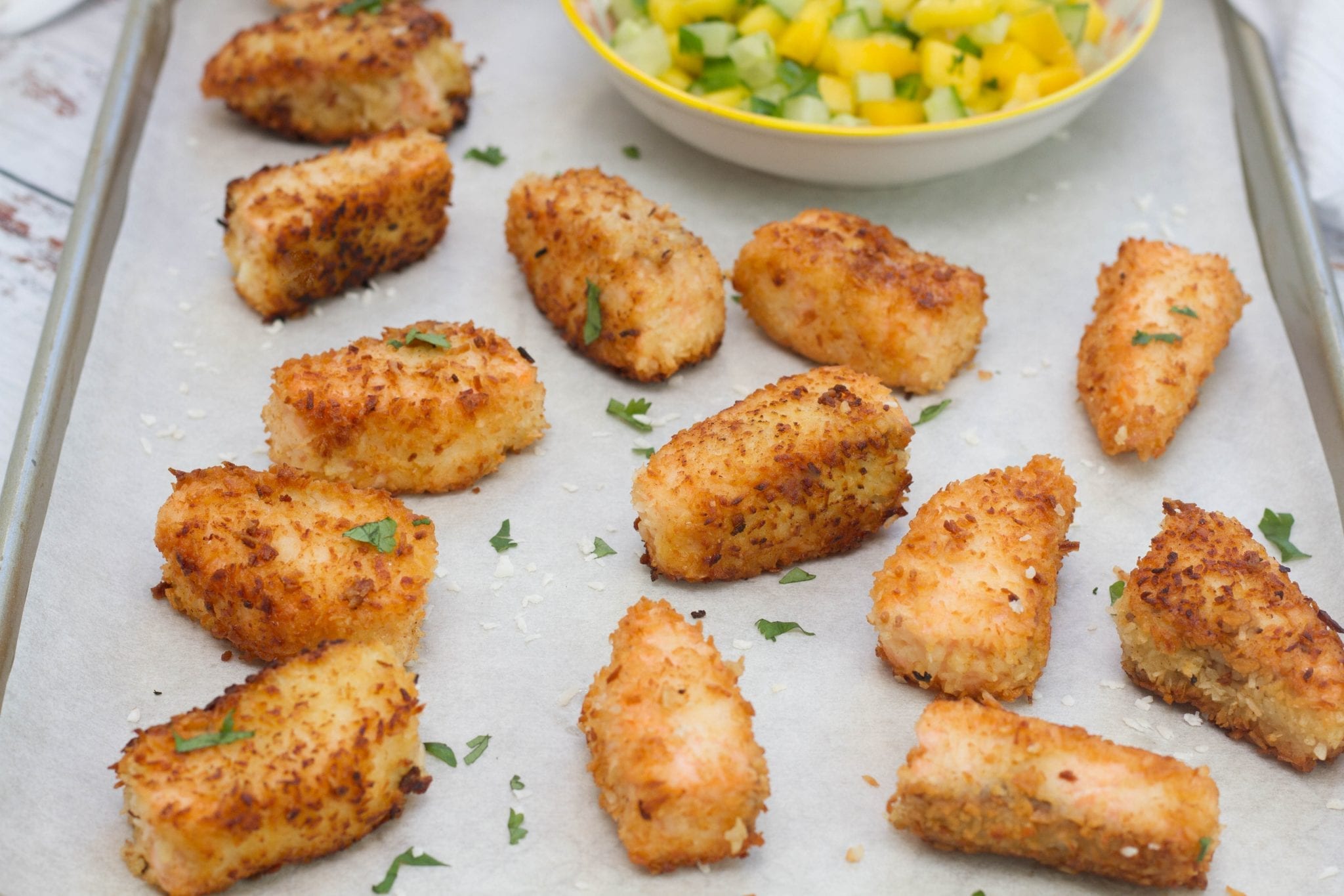 Coconut salmon goujons with mango salsa