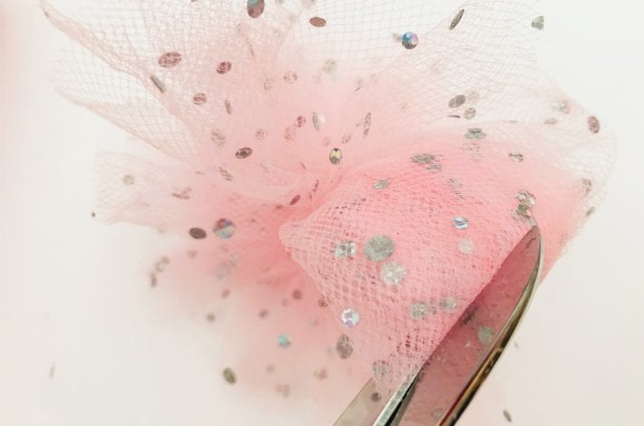 DIY princess party decorations - learn how to make tulle pom pom wands. Arrange tulle pom pom sticks in jars or as table decorations at kids parties.