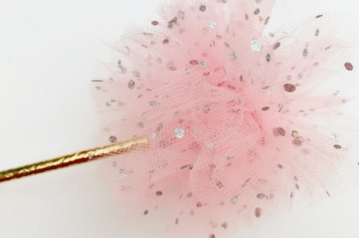 DIY princess party decorations - learn how to make tulle pom pom wands. Arrange tulle pom pom sticks in jars or as table decorations at kids parties.