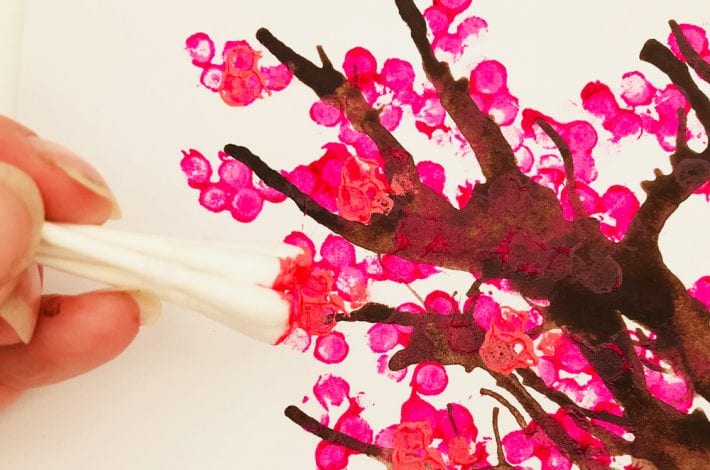 Cotton bud tree art. Make these blow paint and cotton bud printed cherry tree paintings - a great spring craft for kids