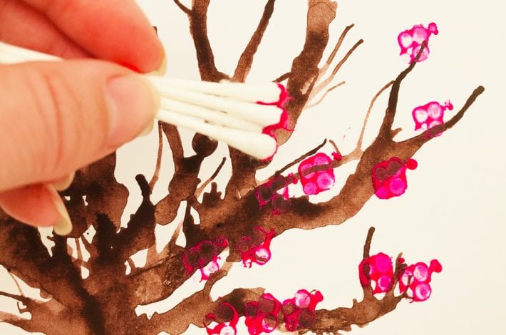 Cotton bud tree art. Make these blow paint and cotton bud printed cherry tree paintings - a great spring craft for kids