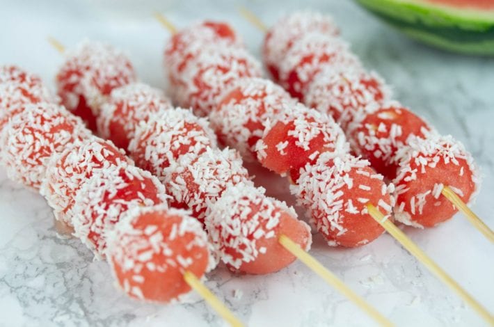 Frozen watermelon kebabs with a drizzle of honey and sprinkle of coconut. The perfect summer snack for kids