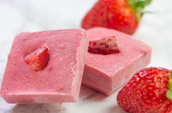 Frozen fruit chew bites made with fresh strawberries and peanut butter and frozen into bars for kids snacks