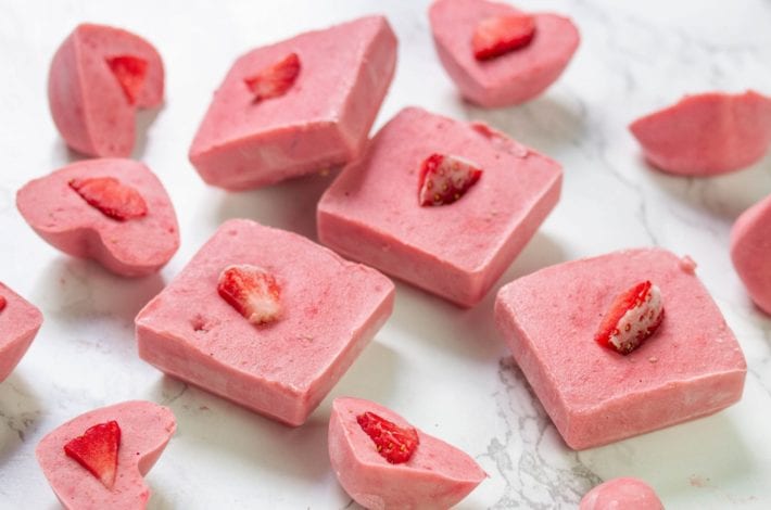 Frozen fruit chew bites made with fresh strawberries and peanut butter and frozen into bars for kids snacks