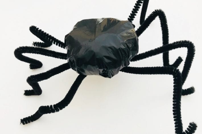 Make these spooky spiders out of the humble trash bag - a great Halloween spider craft for toddlers and kids to enjoy