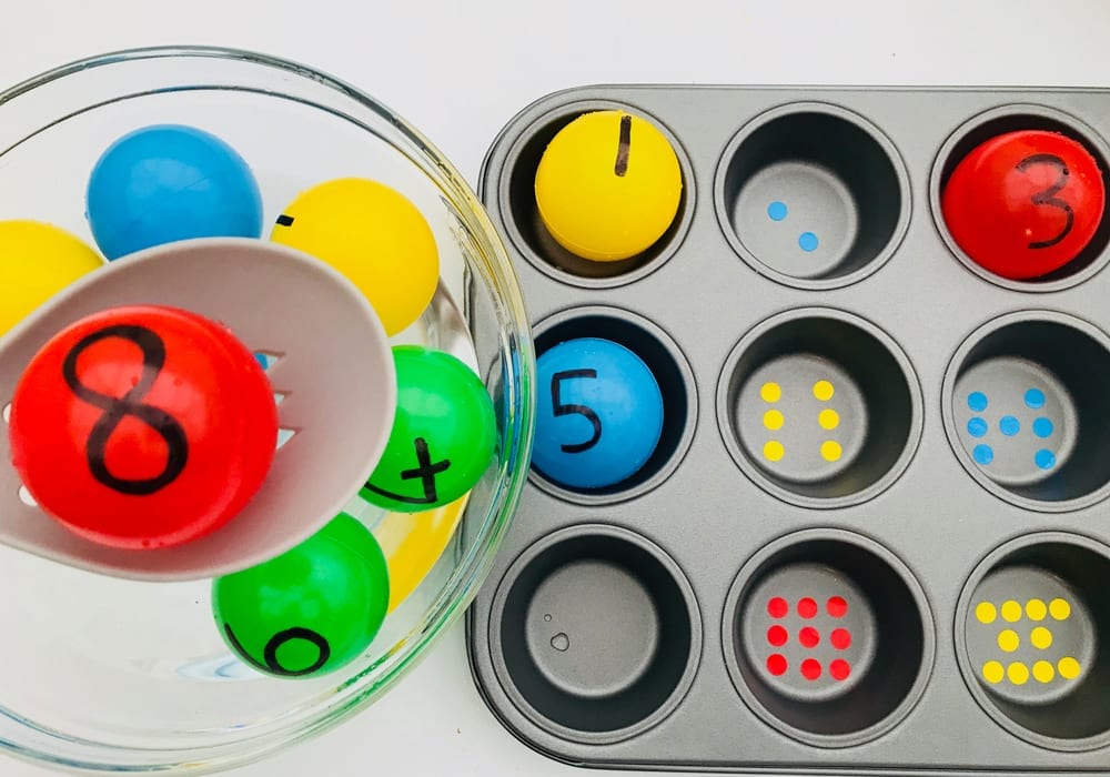 Make a fun number recognition game with these colourful balls. Fish out each number and match it to the right number of dots in the muffin tray.