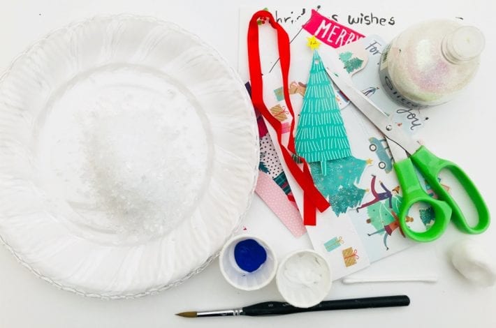 how to make clear paper plate snow globe crafts - a quick and easy Christmas craft to enjoy with kids that's just magical