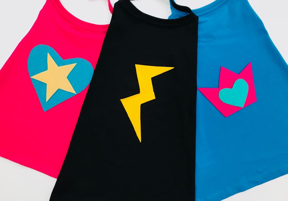 These no-sew superhero capes are genius. Make them as a fun kids craft at home for dressing up or school costumes. A great superhero t-shirt cape to make in minutes.